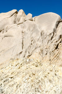 Low angle view of rock formation on land against sky