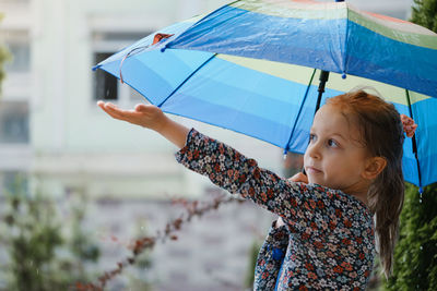 Portrait of woman holding umbrella