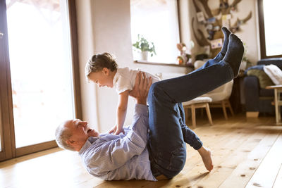 Grandfather and grandson having fun at home