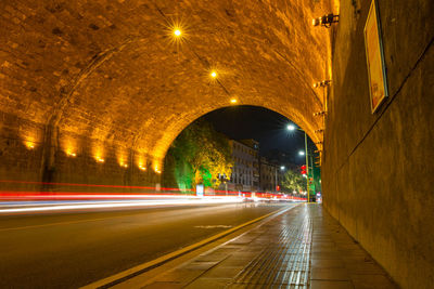 Light trails on road in illuminated tunnel