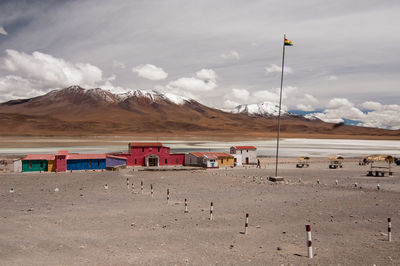 Houses on field against mountains