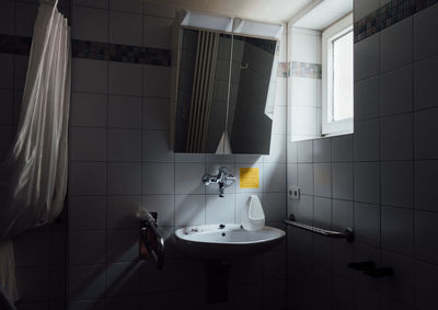 Mirror on wall over sink in bathroom