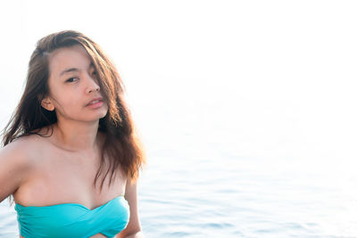 Portrait of beautiful woman standing in sea