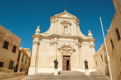 Low angle view of historic building against clear blue sky