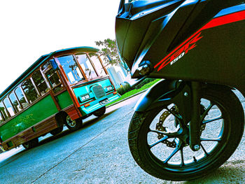 Low angle view of vehicles on road against sky