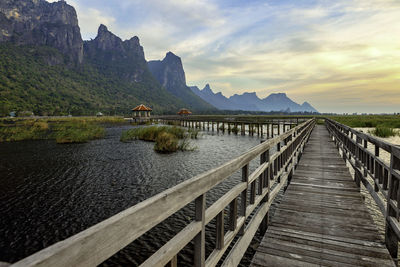 Scenic view of lake by mountains against sky