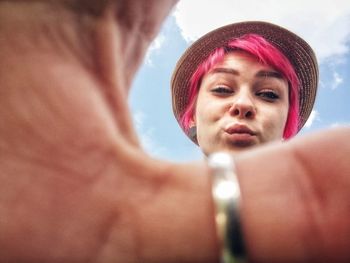 Close-up portrait of woman with pink hair