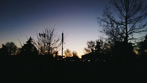 Silhouette trees against sky at sunset