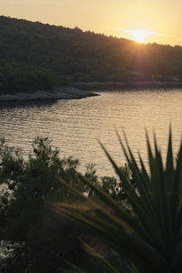 Scenic view of lake against sky during sunset
