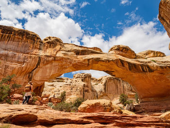 Low angle view of rock formation against cloudy sky