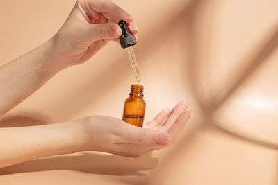 Cropped hand of person holding syringe