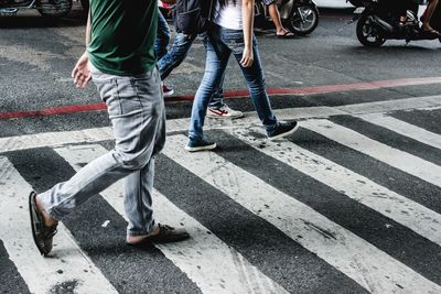 Low section of people standing on road