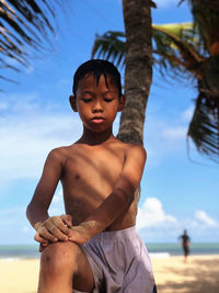 Full length of shirtless boy against sky