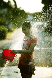 Water spraying on smiling girl