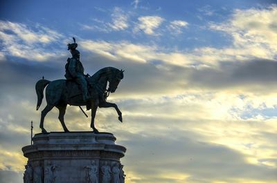 Low angle view of statue against cloudy sky