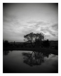 Reflection of trees in lake against sky