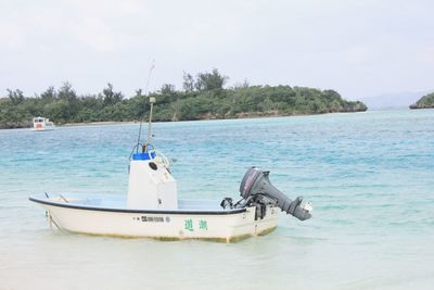 Boat at beach against sky