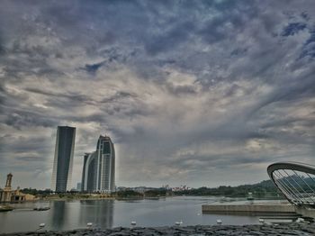 View of modern buildings against cloudy sky