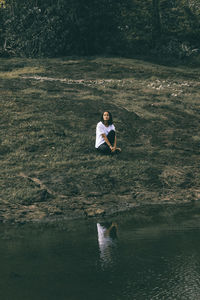 Full length of man sitting on land