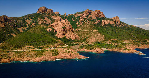 Scenic view of sea and mountains against sky