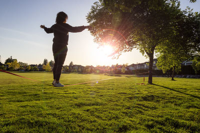 Man playing soccer on field against trees