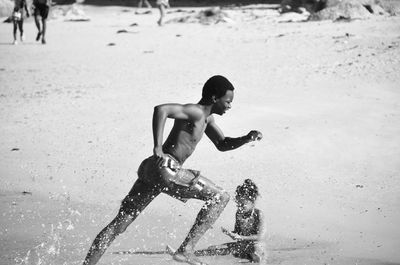 Young man running on beach