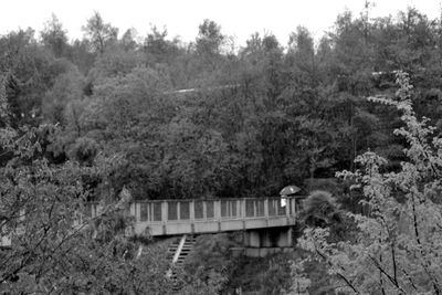 Built structure on landscape against trees