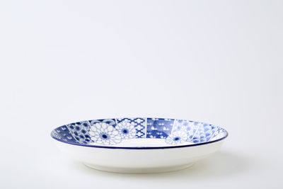 Close-up of bowl over white background