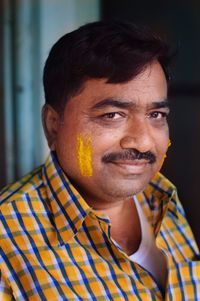 Portrait of a man in wedding festival with turmeric 