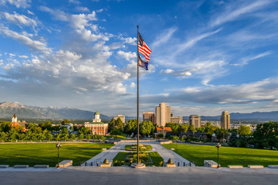 Flag by building against sky in city