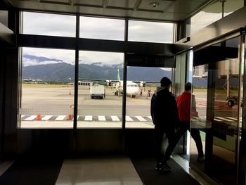 Rear view of man at airport runway