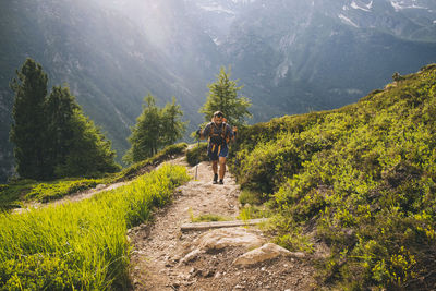 Man hiker going up to aiguillette des posettes, french alps, chamonix