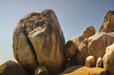 Low angle view of rock formation against sky