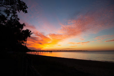 Scenic view of sea against romantic sky at sunset