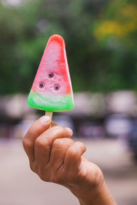 Close-up of hand holding ice cream cone