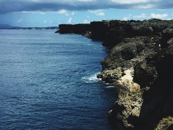 Scenic view of sea against cloudy sky