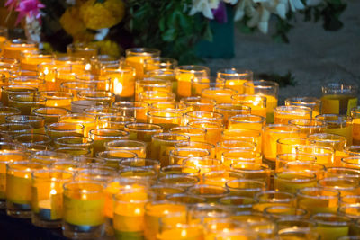 Close-up of lit tea light candles in row