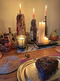 Close-up of illuminated candles on table