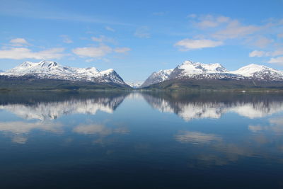 Scenic view of lake and mountains against sky during winter