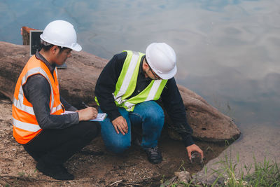 Technicians and engineers discuss work together working at water recycling plant for reuse