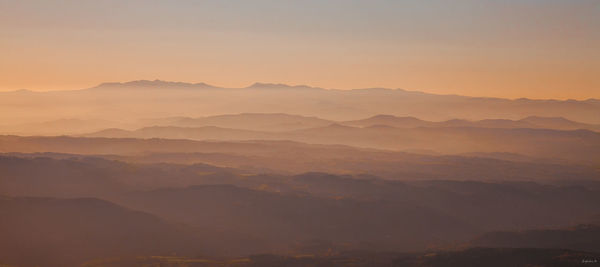 Scenic view of mountains against sky during sunset