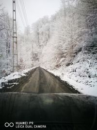 Road passing through snow covered landscape