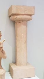 Close-up of hand holding stone wall