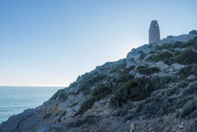 Scenic view of sea by buildings against clear sky