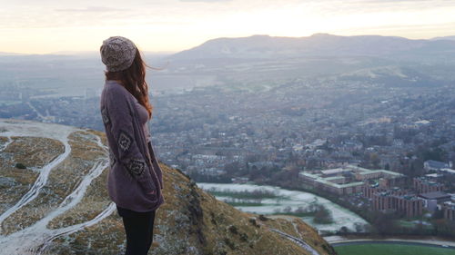 Rear view of woman looking at cityscape