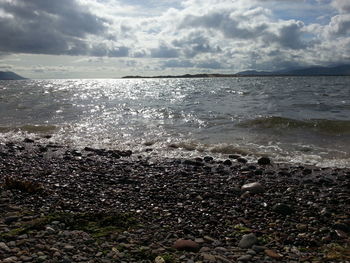 Scenic view of sea against cloudy sky