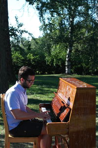 Man playing piano in garden