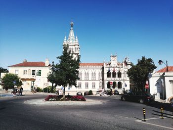 Buildings in city against blue sky