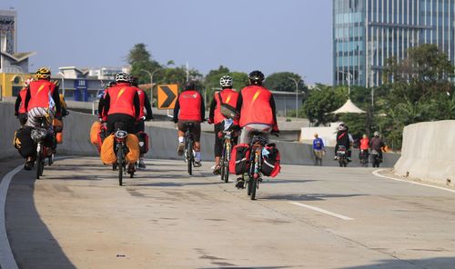 People on road in city against sky