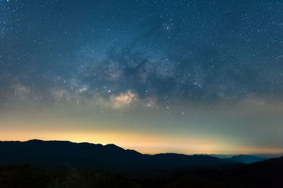 Scenic view of silhouette mountain against sky at night